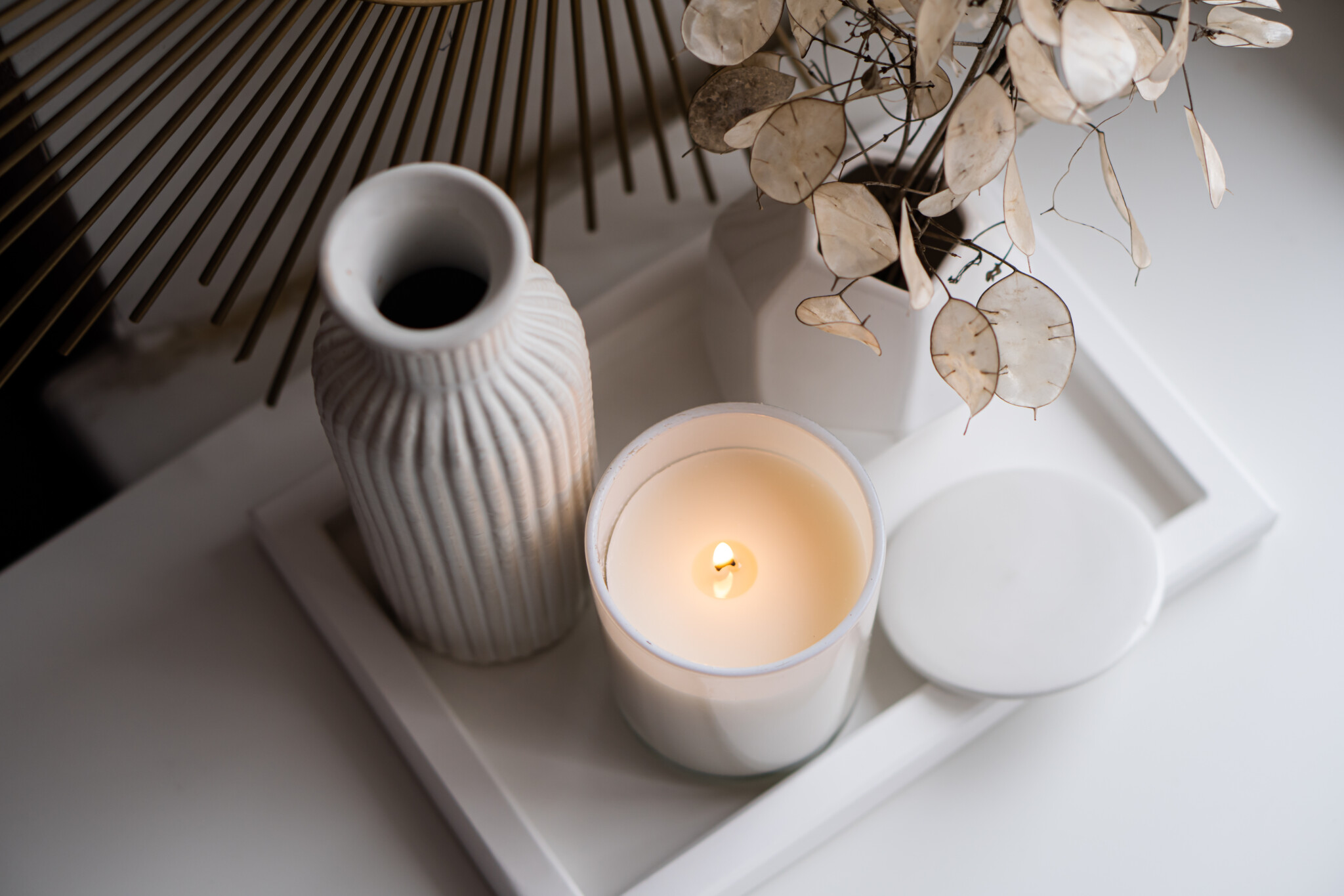 Luxurious white tray decoration, home interior decor with burning candle and mirror, close-up