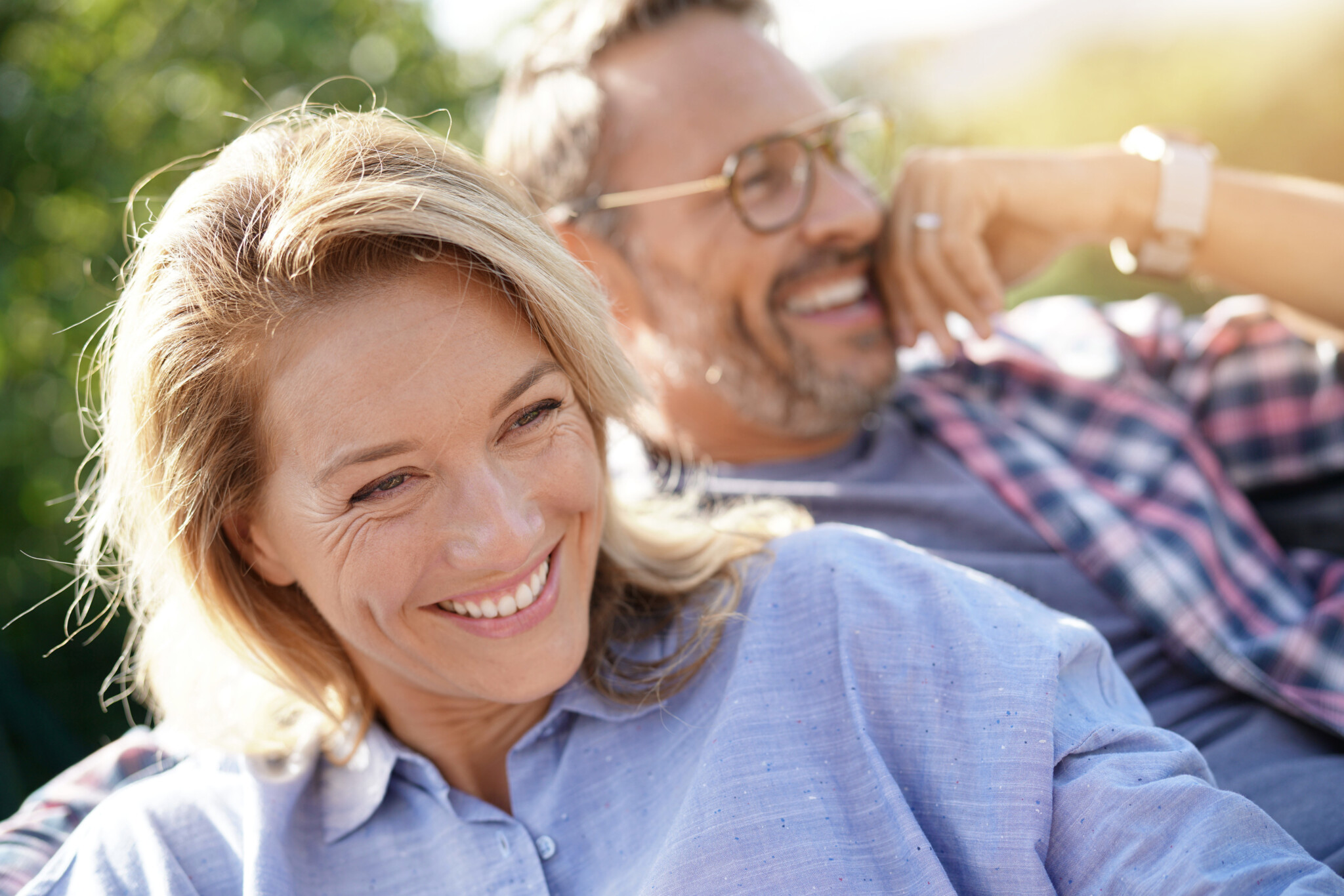 Portrait of mature couple relaxing in outdoor sofa